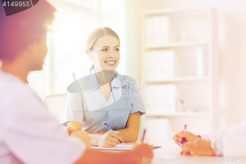 Image of group of happy doctors meeting at hospital office