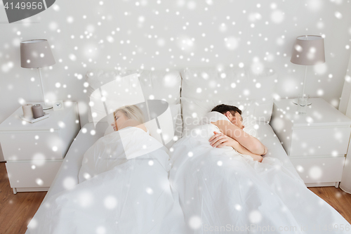 Image of couple sleeping in bed at home