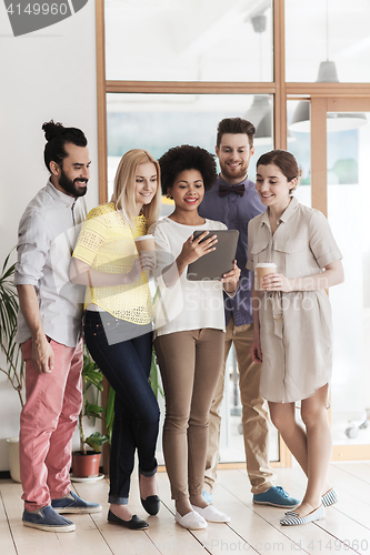 Image of creative team with tablet pc and coffee at office