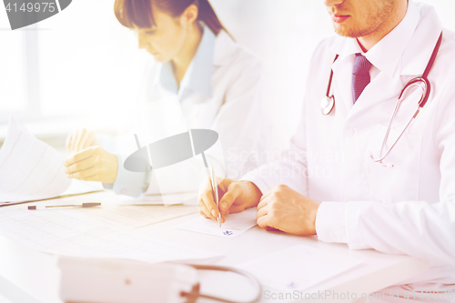 Image of doctor and nurse writing prescription paper
