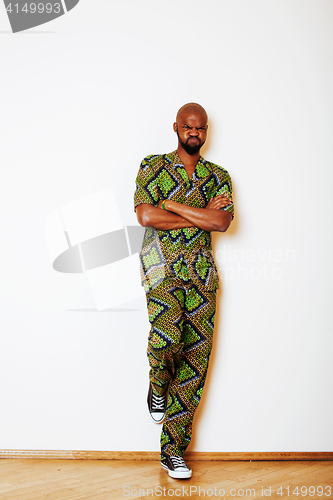 Image of portrait of young handsome african man wearing bright green nati