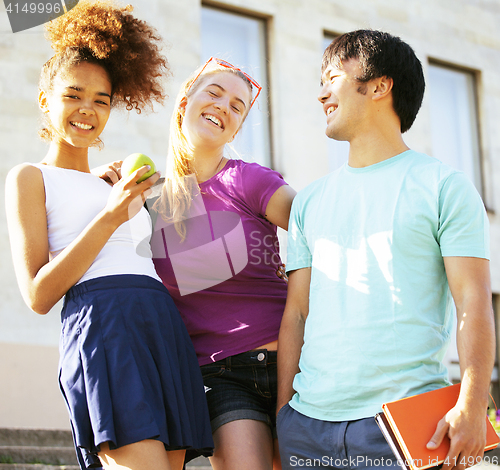 Image of cute group teenages at the building of university with books huggings