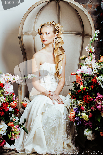 Image of beauty young bride alone in luxury vintage interior with a lot of flowers close up