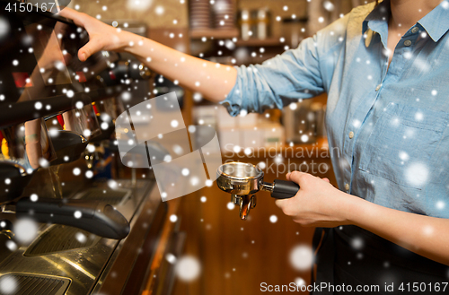 Image of close up of woman making coffee by machine at cafe