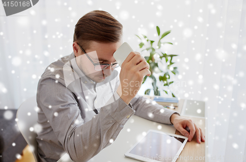 Image of businessman with smarphone at home office