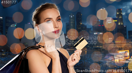 Image of woman with credit card and shopping bags