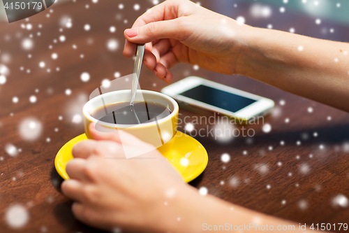 Image of close up of woman with smartphone and coffee