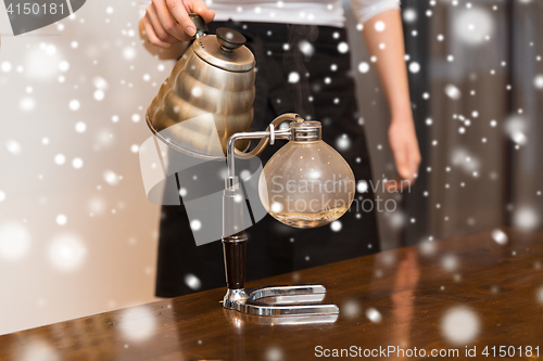 Image of close up of woman with siphon coffee maker and pot