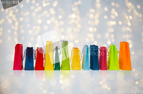 Image of shopping bags over holidays lights background