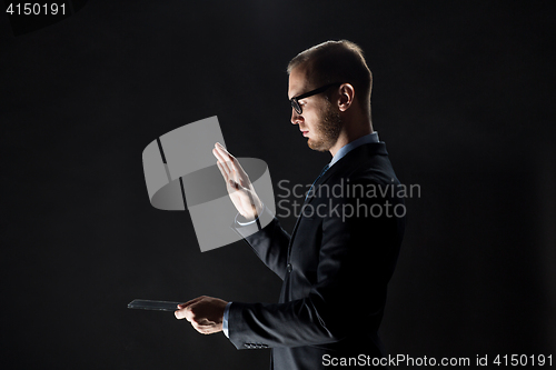 Image of close up of businessman with transparent tablet pc