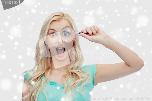 Image of happy young woman with magnifying glass