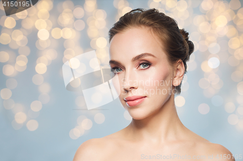 Image of beautiful young woman face over white background