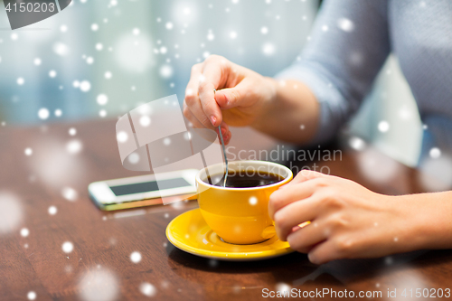 Image of close up of woman with smartphone and coffee