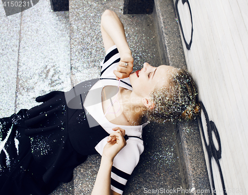 Image of young pretty party girl smiling covered with glitter tinsel, fas