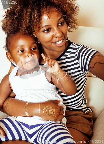 Image of adorable sweet young afro-american mother with cute little daughter, hanging at home, having fun playing smiling, lifestyle people concept, happy smiling modern family