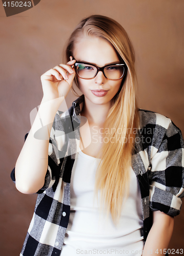 Image of young happy smiling hipster blond girl with backpack ready to sc