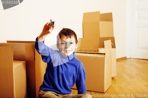 Image of little cute boy in empty room, remoove to new house. home alone, lifestyle people concept