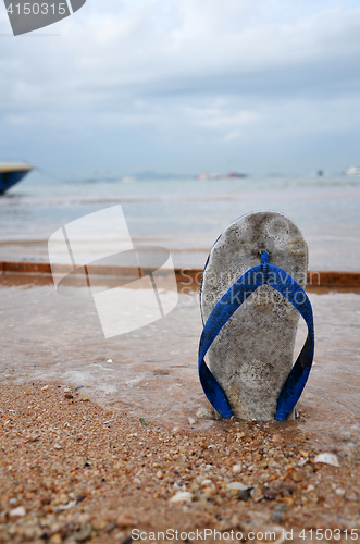 Image of Beach slippers on a sandy beach