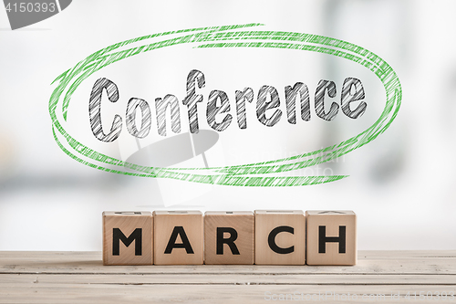 Image of March conference with a wooden sign