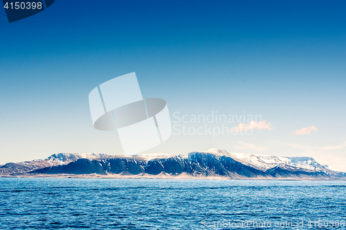 Image of Snow on mountains in the blue ocean