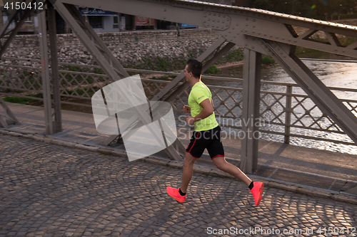 Image of a young man jogging in the city