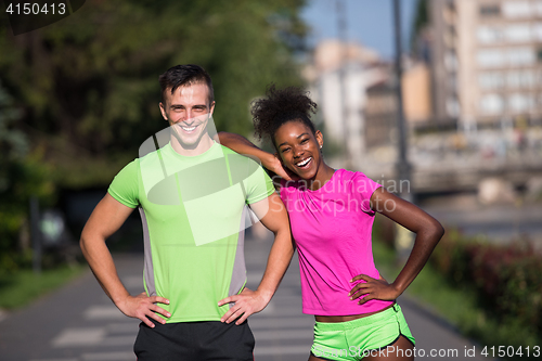 Image of portrait of young multietnic jogging couple ready to run