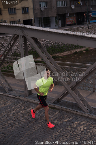 Image of a young man jogging in the city