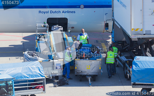 Image of AMSTERDAM, NETHERLANDS - AUGUST 17, 2016: Loading luggage in air