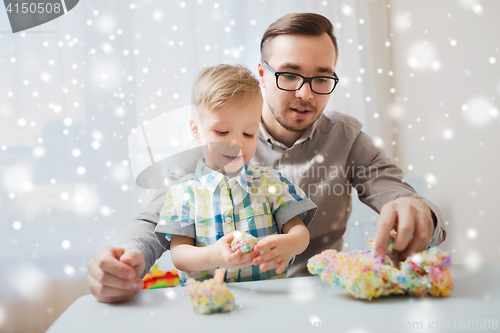 Image of father and son playing with ball clay at home