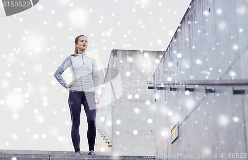 Image of sporty woman standing on in city stairs
