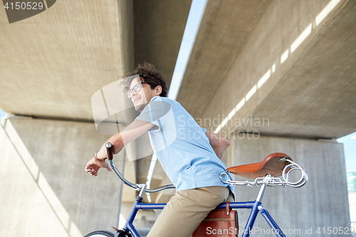 Image of young hipster man riding fixed gear bike