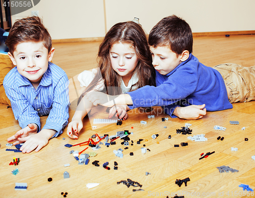 Image of funny cute children playing lego at home, boys and girl smiling, first education role lifestyle