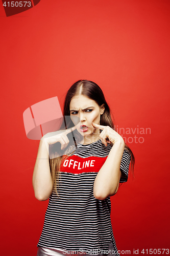 Image of young pretty emitonal posing teenage girl on bright red background, happy smiling lifestyle people concept