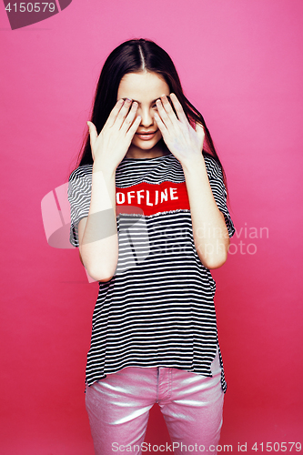Image of young pretty teenage woman emotional posing on pink background, fashion lifestyle people concept