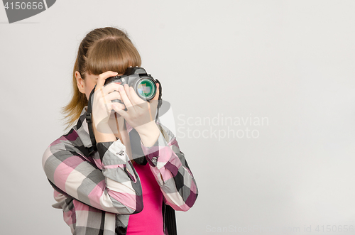 Image of Portrait of a girl the photographer photographing camera