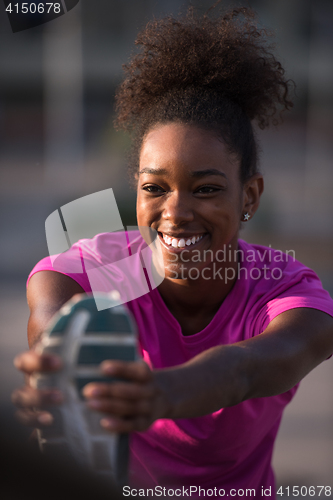 Image of African American woman doing warming up and stretching