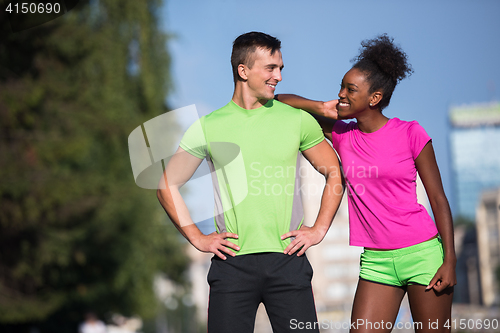 Image of portrait of young multietnic jogging couple ready to run