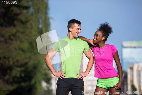 Image of portrait of young multietnic jogging couple ready to run