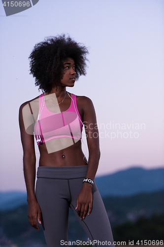 Image of portrait of african american woman jogging in nature