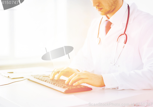 Image of male doctor typing  on the keyboard