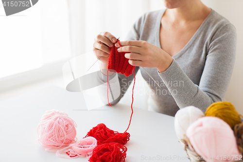 Image of woman hands knitting with needles and yarn