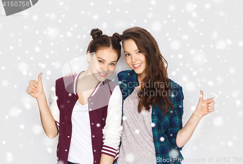 Image of happy smiling teenage girls showing thumbs up