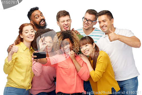 Image of group of people taking selfie by smartphone