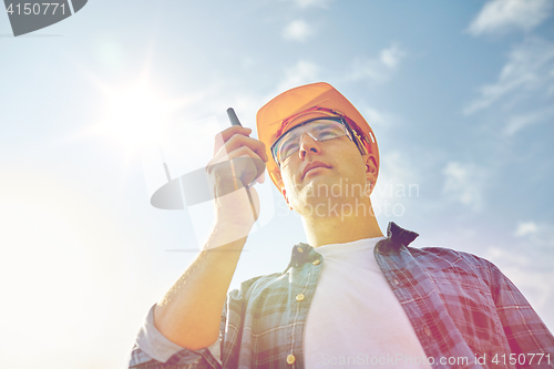 Image of builder in hardhat with walkie talkie