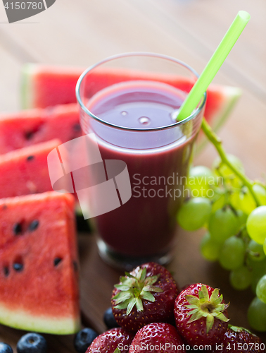 Image of glass of fruit  juice or smoothie with straw