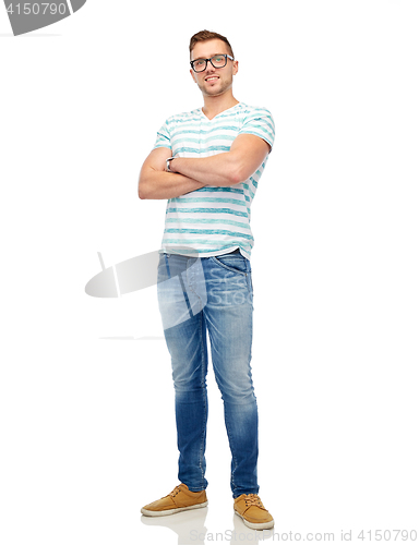 Image of smiling young man in eyeglasses over white