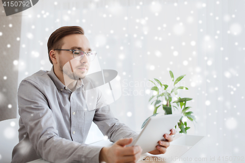 Image of creative male worker with tablet pc at home office