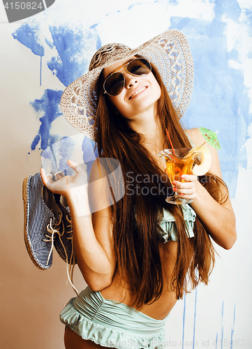 Image of cute bright woman in sunglasses and hat with cocktail in bikini 