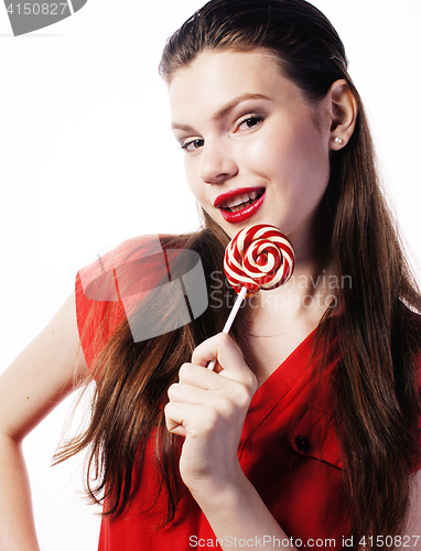 Image of young pretty brunette girl with red candy posing on white background isolated