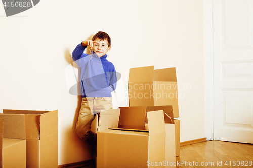 Image of little cute boy in empty room, remoove to new house. home alone, lifestyle people concept